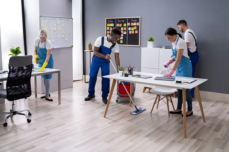 A team of cleaners cleaning an office in London