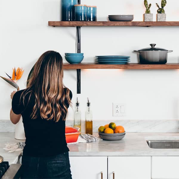 a woman cleans the kitchen